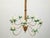 A vintage painted tôle palm tree light fixture from the mid 20th century, with 10 lights and swoop arms. Created during...