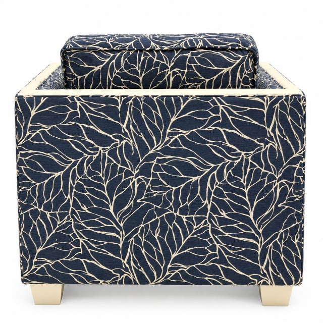 This is a pair of 1960s Hollywood Regency faux bamboo club chairs. They are not marked. The fabric is a navy and white...