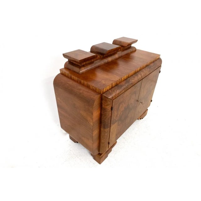 Art Deco chest of drawers from the 1940s, Poland. A chest of drawers with one shelf. The whole thing is veneered with...