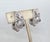 1960s rhodium plated filigree with raised tear drop shapes half hoop clip earrings. Marked crown "TRIFARI©" on the clips....
