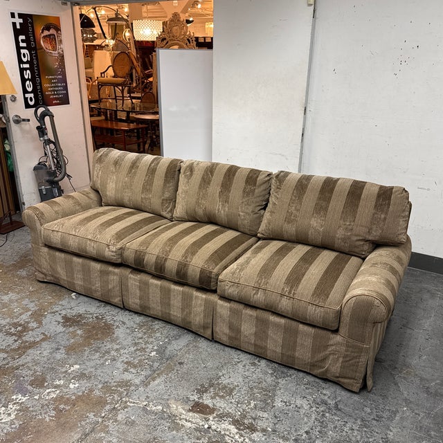 Design Plus Gallery presents a Bespoke Rolled Arm Sofa from Belmar Furniture. This three-seat sofa is upholstered in taupe...