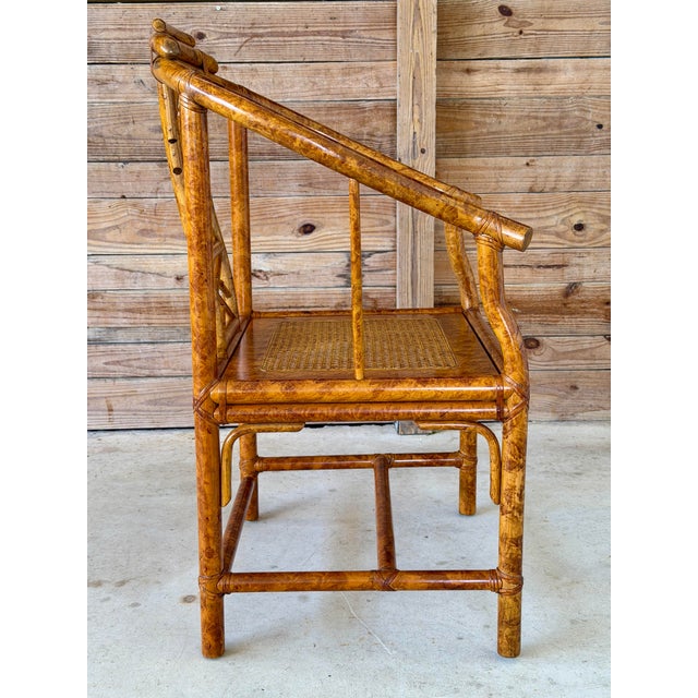A beautifully crafted vintage Chinoiserie horseshoe side chair featuring a richly detailed tortoise faux bamboo finish,...