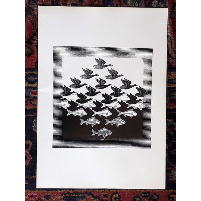 This vintage 20th century lithograph (offset) depicts one of M. C. Escher's (Netherlands 1898-1972) fascinating and iconic...
