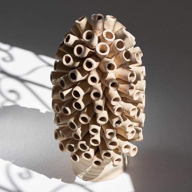 Intriguing and geometric, this Tamegroute terracotta piece features cylindrical segments crafted with precision, creating...