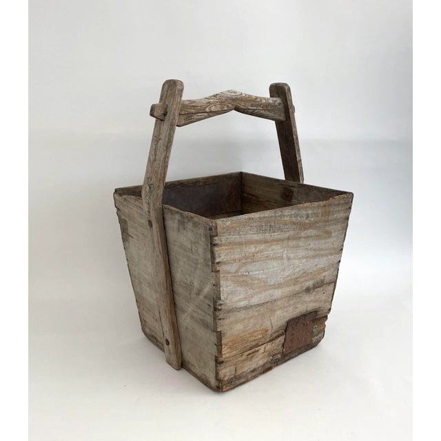 This antique Chinese wooden box was used for transporting water. Age has left it with nice patina and patches as...