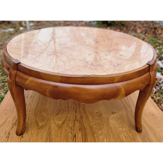 This solidly constructed 1954 coffee table is unusual for having an inset marble top. The warm finish of the fruitwood...