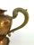 A substantial vintage copper teapot accented with ornate brass detailing, crafted in a classic French-inspired form. The...