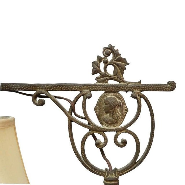 An antique bridge lamp by Rembrandt, crafted circa 1930, showcasing an elegant blend of cast iron and brass. This piece...