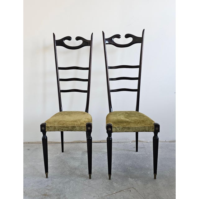 A pair of Mid Century Modern High backrest Chairs attr. to Italian star of design, Paolo Buffa. The chairs are done in...