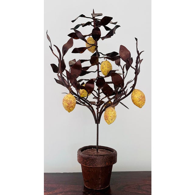 This is an unusual tole lemon topiary tree in a heavy brown tole metal pot. The lemons are made of some sort of stone. The...