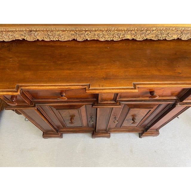 Venetian corner cupboard with pillars and uprights corresponding to drawers. Mixed cherry and walnut woods. Period late...