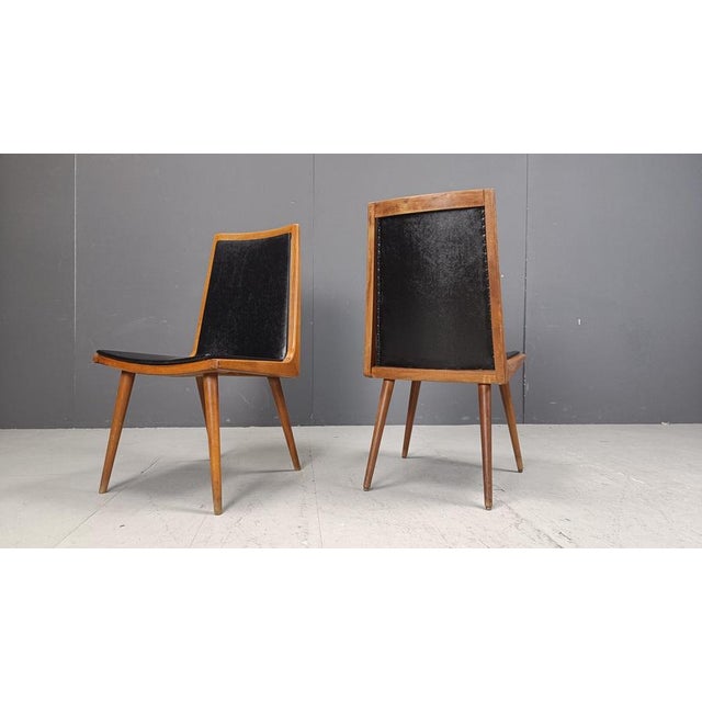 Mid century modern 'boomerang' design dining chairs with black skai upholstery. Beautiful elegant design. 1950s - Italy...