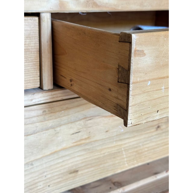 A beautiful French provincial pine armoire with paneled doors, carved architectural detailing and a wonderfully warm,...
