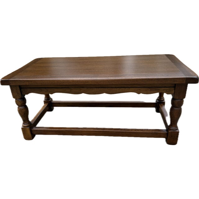 Beautiful solid wood coffee table with scalloped trim, turned legs and bottom stretchers. Very substantial. I have an end...
