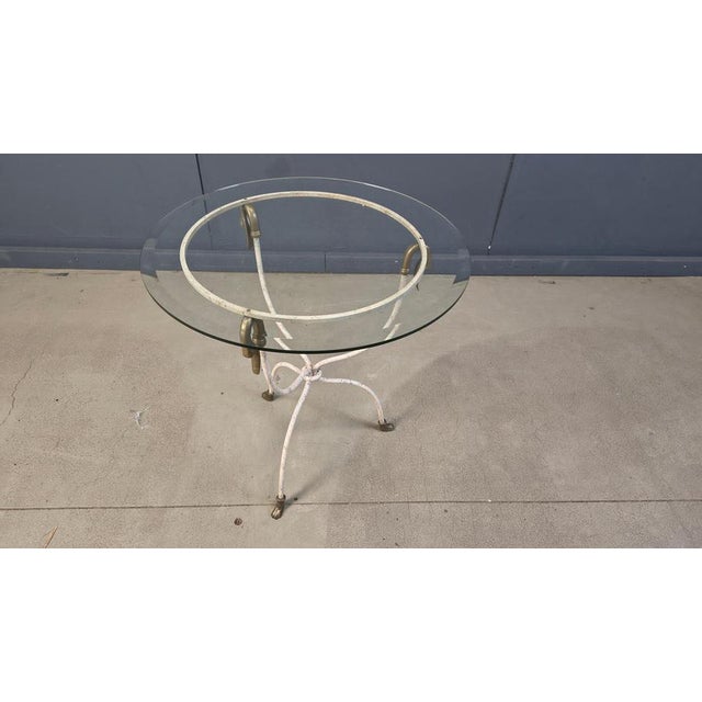Hollywood regency brass swan side table. Beautiful white wrought iron base with brass clawfeet and swan shaped table top...