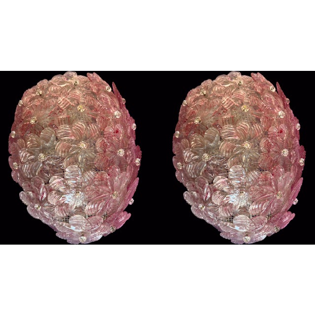 Pair of stunning bright pink colored wall lights. They are formed by dozens of small roses made of pure Murano glass. Up...