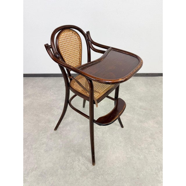A delightful and exceptionally collectible early 20th-century bentwood convertible children's high chair...