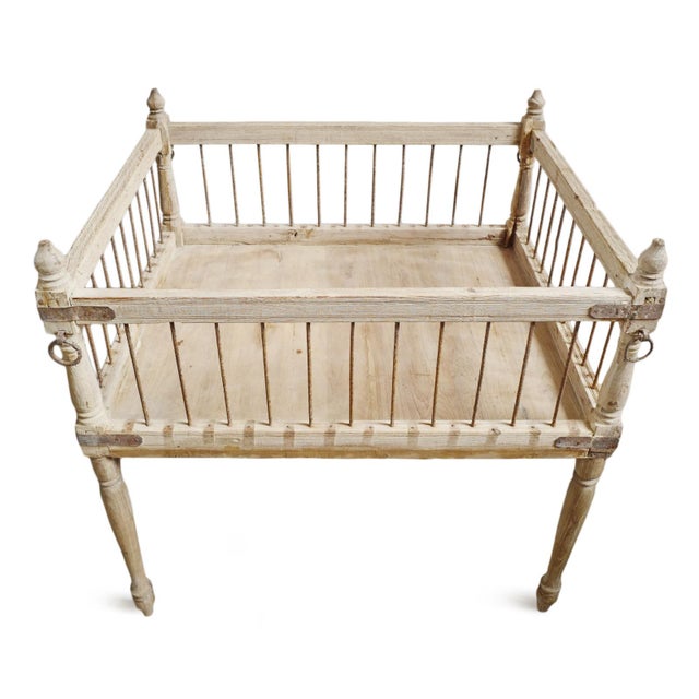 This antique Indian teak piece is a striking example of traditional craftsmanship, featuring a beautifully sun-bleached...