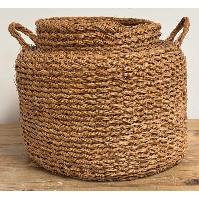 Large vintage woven seagrass basket with handles. Top opening measures 10"dia. Age wear.
