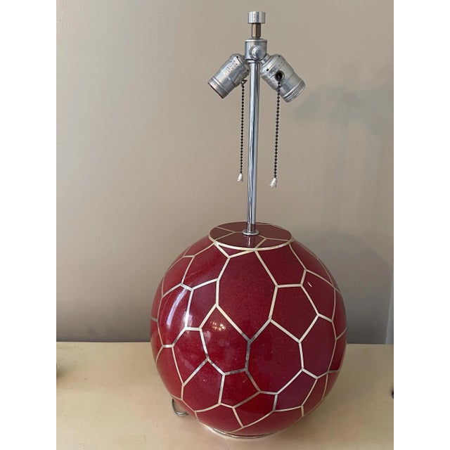 A monumental 1970s sculptural table lamp attributed to Karl Springer, featuring an intricate geodesic honeycomb lattice...