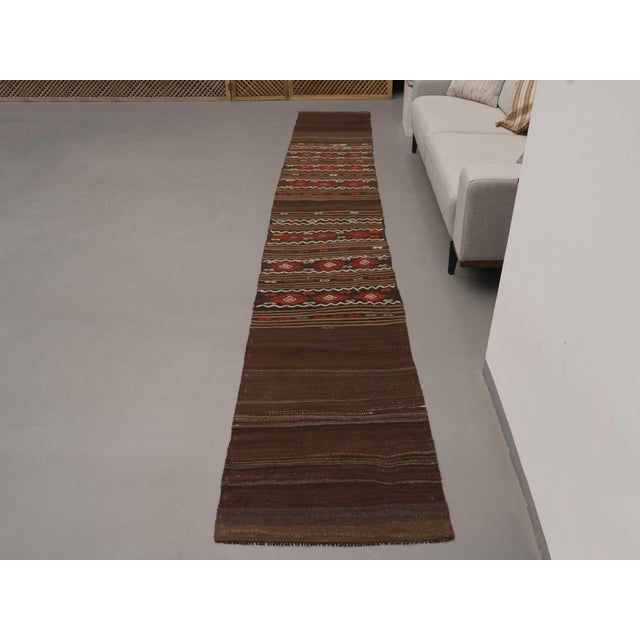 Vintage Hand-Knotted runner rug is a semi-antique vintage area rug. The '70s Eastern region of Anatolia's unique rug is...