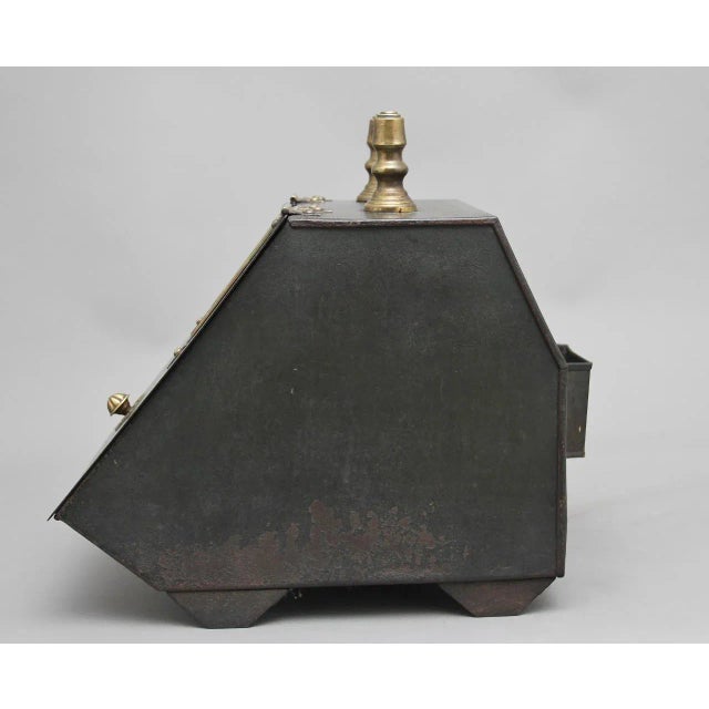 19th Century metal and painted coal box, having a turned brass handle on the top, decorative brass hinges on the lid which...