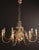 Beautiful eight-armed flemish chandelier made of polished brass. The upper part of the chandelier is decorated with fish....