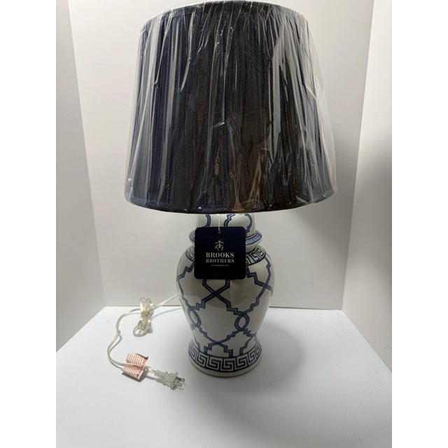 Elevate your home décor with this striking Brooks Brothers Home Decor table lamp featuring a crisp white and blue design —...