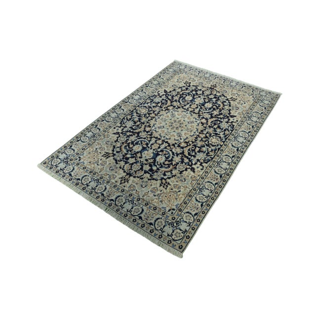 An artfully crafted Nain 9La oriental rug that impresses with its finely woven structure, detailed ornamentation and...