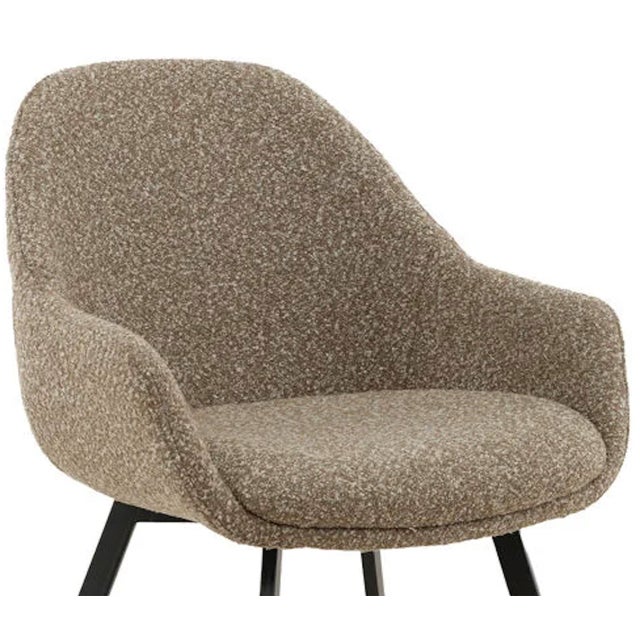 Modern design boucle upholstered dining chair with black iron legs. Neutral toned beige latte color fabric. Weighs approx....