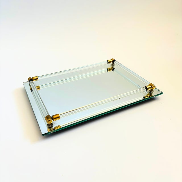 A vintage mirrored glass vanity or bar tray with a cylindrical glass rails to keep your display in place. Lovely details...
