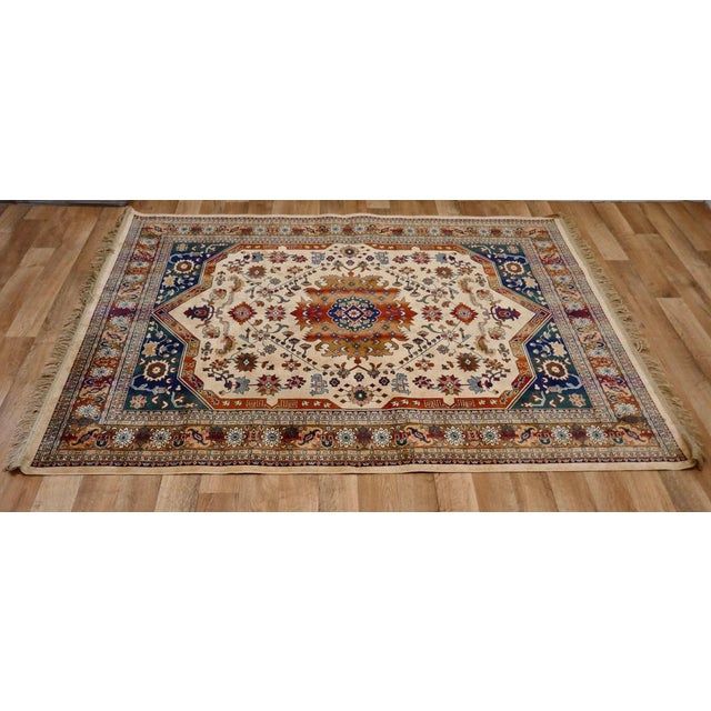 A beautiful traditional tree of life silk rug. The symmetrical centre panel of this intricate and luscious rug focuses on...