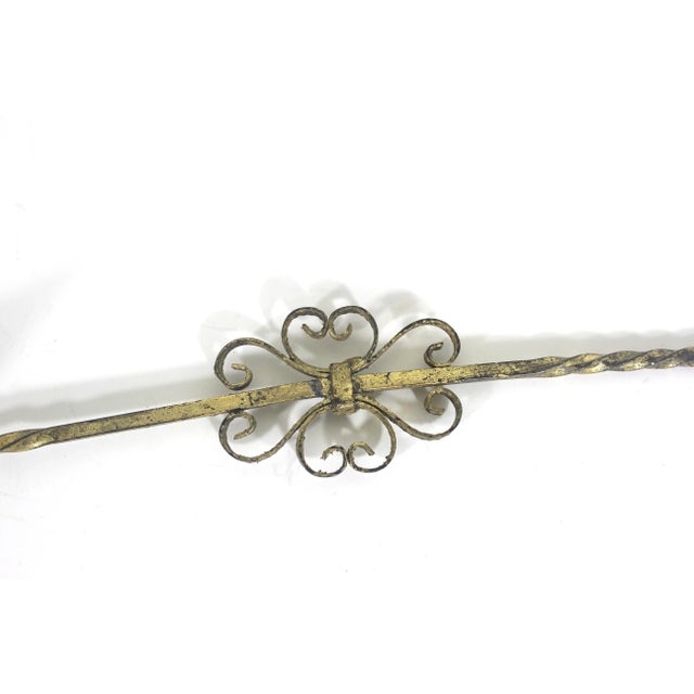 This is a vintage Florentine style wrought iron gilt metal candle snuffer with a twisted handle and a loop at the end and...