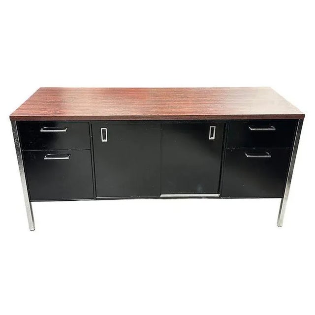 Vintage Modern black enameled steel tanker Credenza with chromed legs and Walnut Laminate Top. This credenza was made by...