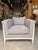 Contemporary accent chair featuring a clean, architectural silhouette upholstered in a soft gray textured fabric for a...