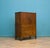 A tiger oak linen press dating from the 1930s, offering practical storage in a compact piece. Raised on Queen Anne...
