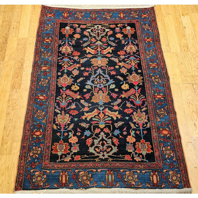 "An exceptional Vintage Persian Malayer area rug, dating to the early 1900s. This captivating piece features an all over...