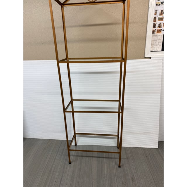 Design Plus Gallery presents a Brass Etagere with a Peaked Top and Geometric Pattern. The simple shelving unit has brass...
