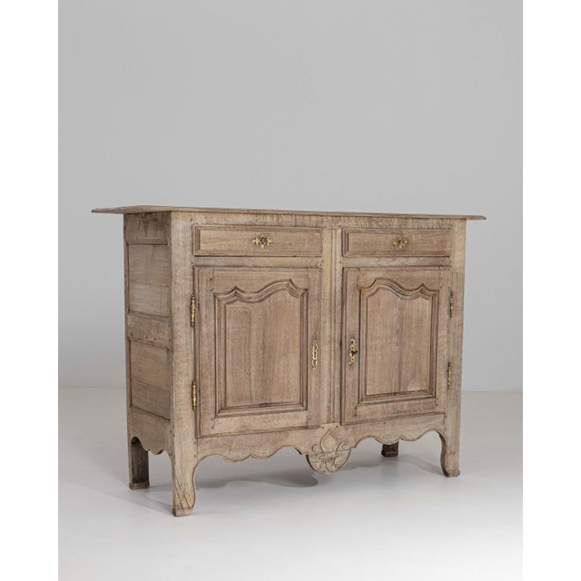 This elegant French oak buffet exemplifies the graceful lines and refined craftsmanship of Louis XV design. Dating to the...