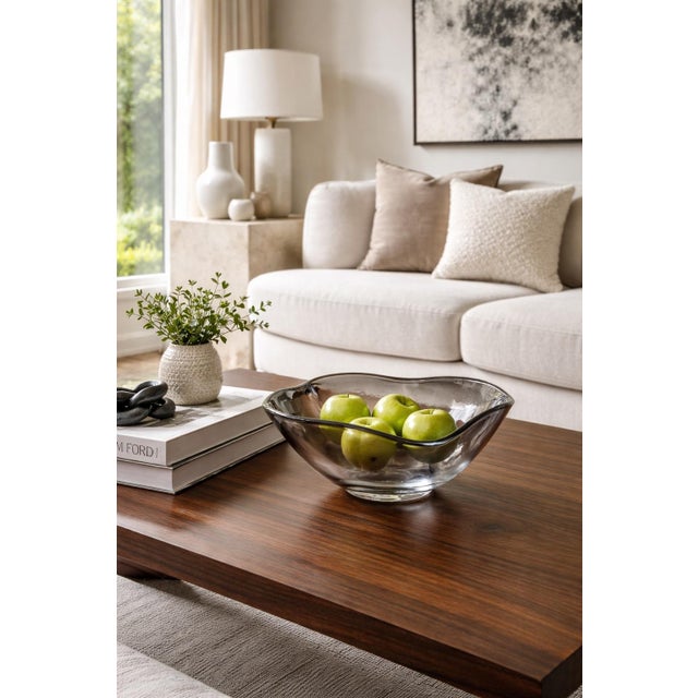 A beautifully sculptural mid-century art glass bowl featuring an elegant freeform silhouette and soft smoky gray hue. The...