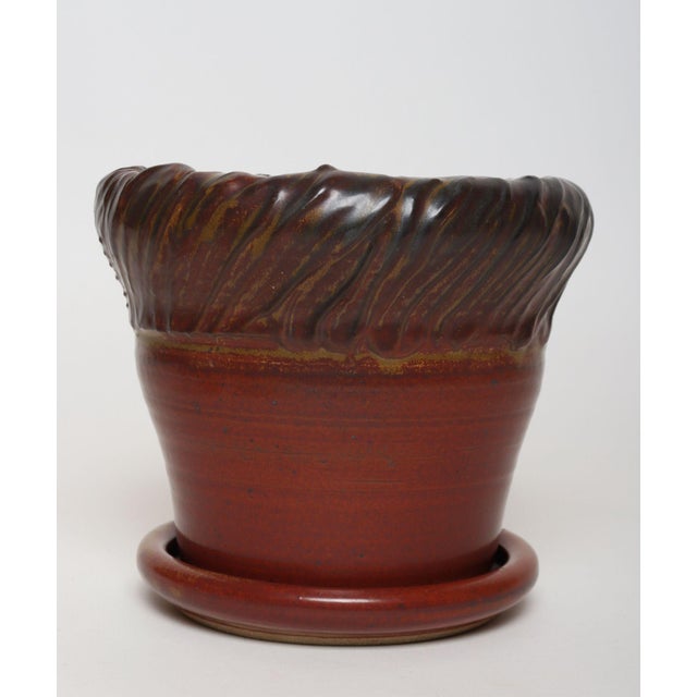 Studio ceramic planter with drainage hole and saucer/plate by ceramicist, Deanna Nichols (b. 1942-2017, Missouri). Holding...