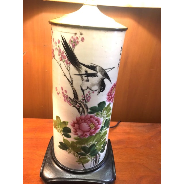 These colorful 19thc hand-painted porcelain vases have been converted into lamps with decorative scrolled teak bases and...