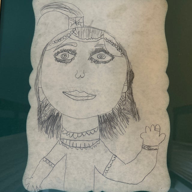 1990’s original folk art female portrait pencil drawing on placemat. Signed and dated on back. Placemat in frame measures...