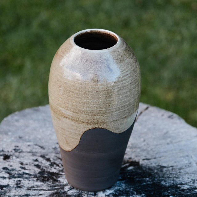 Stoneware vase, wheel-thrown from black stoneware and coated with "Satin White Liner” glaze inside and partially outside....