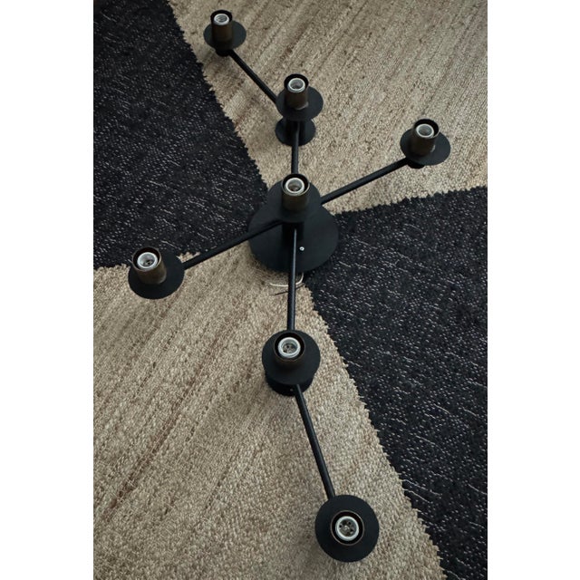 Hinkley 7-arm modern flush mount in matte black with dark antique brass. Architectural form. Includes new universal...