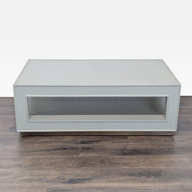 Wood table covered in faux ostrich. Brand: Made Goods. Original Price: $3340. Dimensions (in): 52W x 30D x 19H.