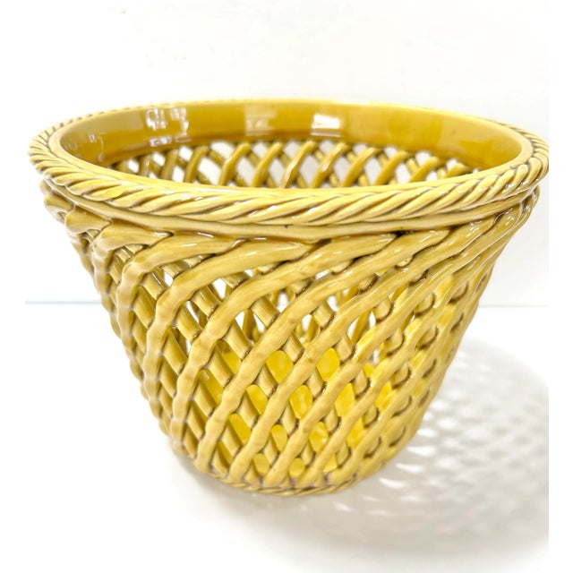 A vibrant vintage Italian porcelain cachepot crafted in an intricate trompe l’oeil basket weave design. The sculpted woven...