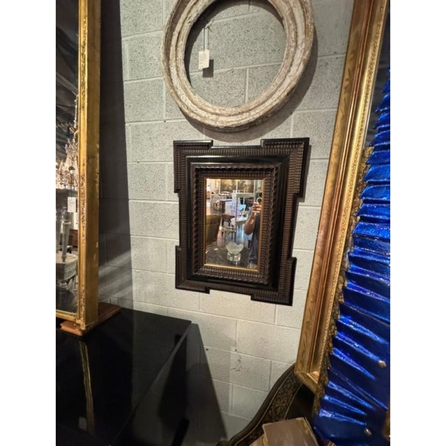 This 19th-century Portuguese carved mirror exudes a unique blend of elegance and history. With intricate detailing and a...