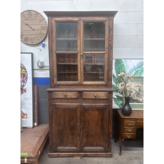 Tall antique French Walnut Cabinet. Note: one pane of glass is missing. Dimensions Base - 43” wide 44” wide crown 92” high...