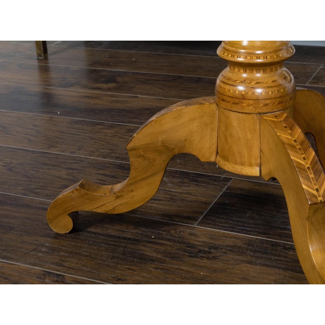 An Italian wooden pedestal side table from the 19th century with octagonal top and marquetry décor depicting Saint George...